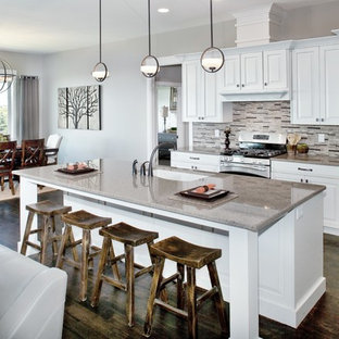 Large transitional eat-in kitchen designs - Inspiration for a large transitional single-wall dark wood floor eat-in kitchen remodel in Salt Lake City with an undermount sink, raised-panel cabinets, white cabinets, quartz countertops, multicolored backsplash, stone tile backsplash, stainless steel appliances and an island