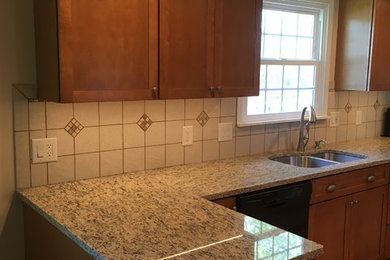 Example of an arts and crafts u-shaped kitchen design in Other with shaker cabinets, granite countertops and porcelain backsplash