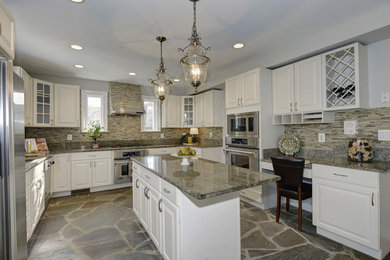 Kitchen - mid-sized traditional u-shaped slate floor kitchen idea in DC Metro with an undermount sink, raised-panel cabinets, white cabinets, granite countertops, beige backsplash, matchstick tile backsplash, stainless steel appliances and an island
