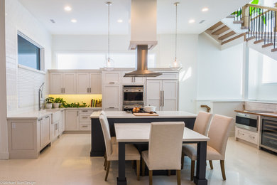 Inspiration for a large transitional l-shaped concrete floor eat-in kitchen remodel in Calgary with a farmhouse sink, recessed-panel cabinets, white cabinets, quartz countertops, white backsplash, ceramic backsplash, paneled appliances and an island