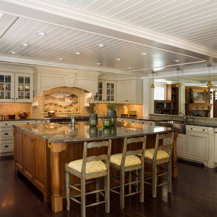 Design ideas for a traditional kitchen in Boston with glass-front cabinets, beige cabinets, granite benchtops, multi-coloured splashback and a farmhouse sink.