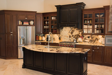 Inspiration for a timeless kitchen remodel in Tampa with brown cabinets, granite countertops, stone slab backsplash, black appliances and an island