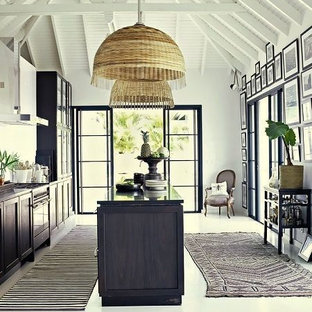 Inspiration for a mid-sized tropical galley open plan kitchen in Seattle with an integrated sink, flat-panel cabinets, blue cabinets, marble benchtops, white splashback, panelled appliances, medium hardwood floors and no island.