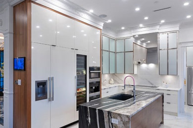 Mid-sized eclectic l-shaped multicolored floor eat-in kitchen photo in Vancouver with an undermount sink, flat-panel cabinets, white cabinets, quartzite countertops, white backsplash, paneled appliances, an island and black countertops