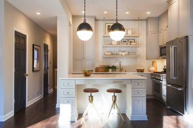 Small trendy l-shaped dark wood floor and brown floor open concept kitchen photo in Orange County with an undermount sink, shaker cabinets, gray cabinets, solid surface countertops, white backsplash, mosaic tile backsplash, stainless steel appliances, an island and white countertops