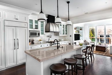 Example of a large transitional galley dark wood floor and brown floor eat-in kitchen design in Chicago with an undermount sink, beaded inset cabinets, white cabinets, marble countertops, white backsplash, subway tile backsplash, paneled appliances and an island