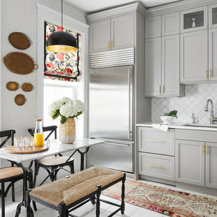 Photo of a mid-sized transitional u-shaped eat-in kitchen in Chicago with an undermount sink, shaker cabinets, grey cabinets, quartz benchtops, white splashback, ceramic splashback, stainless steel appliances, ceramic floors, no island, white floor and white benchtop.