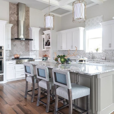 Large transitional l-shaped medium tone wood floor and brown floor kitchen photo in Dallas with an undermount sink, recessed-panel cabinets, white cabinets, gray backsplash, mosaic tile backsplash, stainless steel appliances, an island and gray countertops