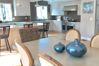 Example of a huge beach style l-shaped eat-in kitchen design in Other