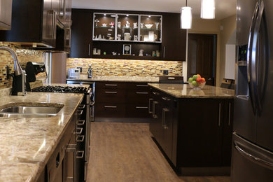 Mid-sized trendy l-shaped vinyl floor eat-in kitchen photo in Detroit with an undermount sink, flat-panel cabinets, dark wood cabinets, quartz countertops, multicolored backsplash, glass sheet backsplash, stainless steel appliances and an island