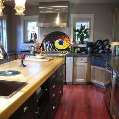 Kitchen pantry - large eclectic u-shaped medium tone wood floor kitchen pantry idea in Toronto with a farmhouse sink, shaker cabinets, medium tone wood cabinets, soapstone countertops, multicolored backsplash, mosaic tile backsplash, stainless steel appliances and an island