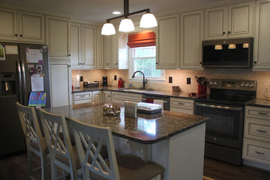 Mid-sized trendy l-shaped kitchen photo in Charlotte with raised-panel cabinets, quartzite countertops and an island
