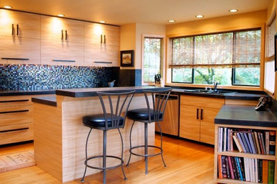 Inspiration for a mid-sized contemporary u-shaped light wood floor eat-in kitchen remodel in Seattle with flat-panel cabinets, light wood cabinets, a double-bowl sink, tile countertops, multicolored backsplash, mosaic tile backsplash, stainless steel appliances and an island
