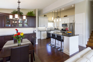Transitional l-shaped brown floor eat-in kitchen photo in Other with an undermount sink, shaker cabinets, white cabinets, quartzite countertops, stainless steel appliances and an island