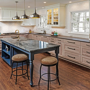 Traditional kitchen designs - Kitchen - traditional l-shaped dark wood floor and brown floor kitchen idea in Milwaukee with an undermount sink, recessed-panel cabinets, medium tone wood cabinets, white backsplash, subway tile backsplash, an island and brown countertops