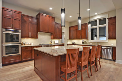 Mid-sized trendy l-shaped light wood floor eat-in kitchen photo in Austin with raised-panel cabinets, medium tone wood cabinets, beige backsplash, stainless steel appliances and an island