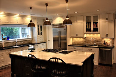 Eat-in kitchen - traditional l-shaped dark wood floor and brown floor eat-in kitchen idea in Cincinnati with an undermount sink, white cabinets, quartzite countertops, green backsplash, subway tile backsplash, stainless steel appliances and an island