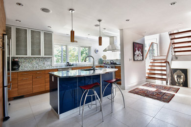 Example of a large trendy u-shaped kitchen design in Boston with an undermount sink, flat-panel cabinets, medium tone wood cabinets, multicolored backsplash, mosaic tile backsplash, stainless steel appliances and an island