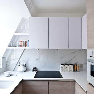 Small trendy u-shaped kitchen photo in London with an undermount sink, flat-panel cabinets, white cabinets, quartz countertops, white backsplash, white appliances, no island and stone slab backsplash