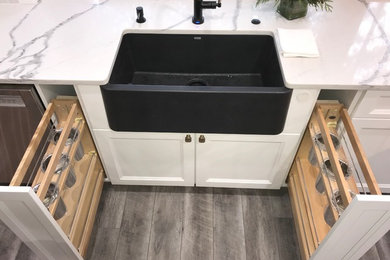 Large trendy u-shaped light wood floor and gray floor eat-in kitchen photo in Portland with an integrated sink, shaker cabinets, white cabinets, quartz countertops, multicolored backsplash, porcelain backsplash, stainless steel appliances, an island and multicolored countertops