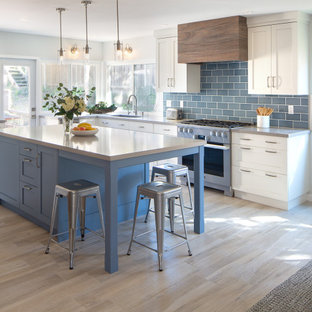 Large beach style u-shaped kitchen in San Diego with an undermount sink, shaker cabinets, blue cabinets, quartz benchtops, blue splashback, porcelain splashback, stainless steel appliances, porcelain floors, with island, beige floor and grey benchtop.