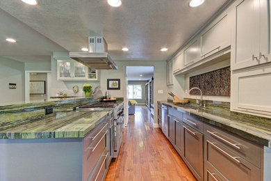 Enclosed kitchen - mid-sized contemporary galley medium tone wood floor enclosed kitchen idea in Los Angeles with an undermount sink, shaker cabinets, gray cabinets, quartzite countertops, green backsplash, stone slab backsplash and stainless steel appliances