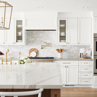 Large scandinavian eat-in kitchen pictures - Eat-in kitchen - large scandinavian l-shaped light wood floor and beige floor eat-in kitchen idea in San Francisco with a farmhouse sink, white cabinets, white backsplash, stainless steel appliances, an island, recessed-panel cabinets, quartzite countertops, marble backsplash and white countertops