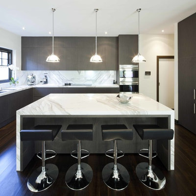 Example of a trendy l-shaped kitchen design in Melbourne with flat-panel cabinets, dark wood cabinets, marble countertops, white backsplash, stainless steel appliances and marble backsplash