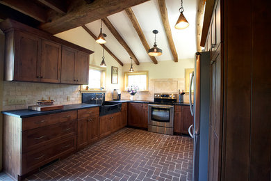 Example of a mid-sized farmhouse u-shaped brick floor eat-in kitchen design in Philadelphia with a farmhouse sink, flat-panel cabinets, medium tone wood cabinets, granite countertops, beige backsplash, subway tile backsplash, stainless steel appliances and no island