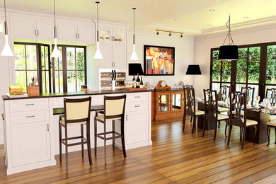 Example of a mid-sized 1960s galley light wood floor eat-in kitchen design in Other with a double-bowl sink, flat-panel cabinets, white cabinets, granite countertops, white backsplash, ceramic backsplash, stainless steel appliances and an island