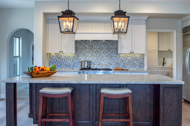 Example of a large transitional u-shaped porcelain tile and beige floor eat-in kitchen design in San Diego with an undermount sink, white cabinets, stainless steel appliances, an island, recessed-panel cabinets, marble countertops, multicolored backsplash, ceramic backsplash and white countertops