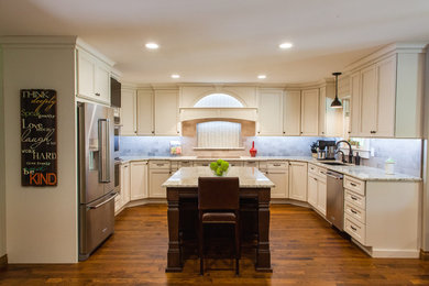 Inspiration for a large transitional medium tone wood floor eat-in kitchen remodel in Wichita with a single-bowl sink, recessed-panel cabinets, white cabinets, granite countertops, multicolored backsplash, stainless steel appliances and an island