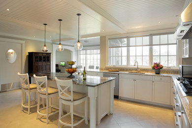Elegant l-shaped ceramic tile eat-in kitchen photo in Boston with a drop-in sink, white cabinets and an island