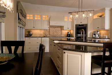Example of a large classic l-shaped ceramic tile eat-in kitchen design in Montreal with an undermount sink, white cabinets, quartzite countertops, beige backsplash, ceramic backsplash, stainless steel appliances, raised-panel cabinets and an island