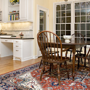 Large traditional eat-in kitchen ideas - Inspiration for a large timeless l-shaped eat-in kitchen remodel in Raleigh with an undermount sink, raised-panel cabinets, white cabinets, granite countertops, white backsplash, subway tile backsplash, white appliances and two islands