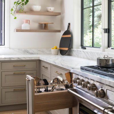 Example of a large transitional light wood floor and beige floor open concept kitchen design in New York with an undermount sink, shaker cabinets, light wood cabinets, marble countertops, white backsplash, marble backsplash, stainless steel appliances, an island and white countertops