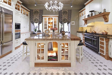 Design ideas for a large traditional kitchen/diner in Other with raised-panel cabinets, medium wood cabinets, marble worktops, ceramic splashback, stainless steel appliances, an island and multi-coloured floors.