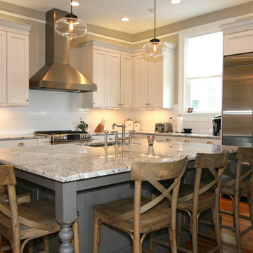 Classically Inspired Kitchen with Stainless Chimney Hood and Pantry Cabinets
