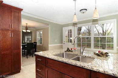 Example of a kitchen design in Cleveland with stainless steel appliances and a peninsula