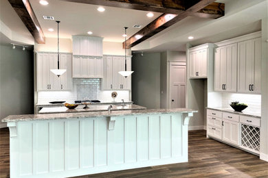 Inspiration for a large craftsman single-wall porcelain tile and multicolored floor eat-in kitchen remodel in Other with an undermount sink, shaker cabinets, white cabinets, granite countertops, white backsplash, stainless steel appliances, two islands, multicolored countertops and subway tile backsplash