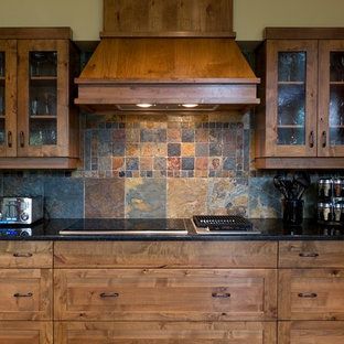 Inspiration for a traditional kitchen in Calgary with multi-coloured splashback, shaker cabinets, medium wood cabinets and slate splashback.