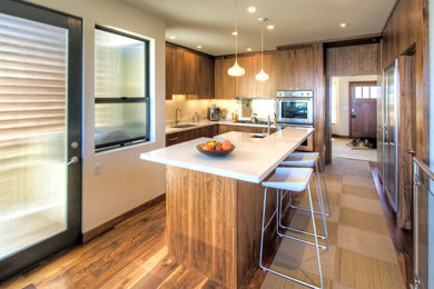 Open concept kitchen - contemporary l-shaped medium tone wood floor open concept kitchen idea in San Francisco with stainless steel appliances, a single-bowl sink, flat-panel cabinets, medium tone wood cabinets, quartzite countertops and an island