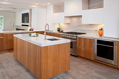 Mid-sized minimalist l-shaped ceramic tile and brown floor eat-in kitchen photo in New York with an undermount sink, flat-panel cabinets, medium tone wood cabinets, granite countertops, white backsplash, stone slab backsplash, stainless steel appliances, an island and gray countertops