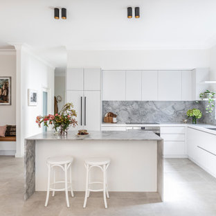Design ideas for a mid-sized contemporary l-shaped open plan kitchen in Sydney with an undermount sink, white cabinets, marble benchtops, grey splashback, marble splashback, ceramic floors, with island, grey benchtop, flat-panel cabinets, panelled appliances and grey floor.