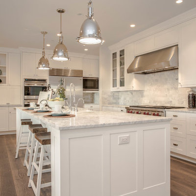 Farmhouse l-shaped dark wood floor kitchen photo in Seattle with shaker cabinets, white cabinets, marble countertops, white backsplash, stainless steel appliances and marble backsplash