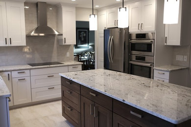 Inspiration for a large transitional u-shaped porcelain tile and white floor eat-in kitchen remodel in Calgary with an undermount sink, shaker cabinets, white cabinets, granite countertops, white backsplash, porcelain backsplash, stainless steel appliances and an island