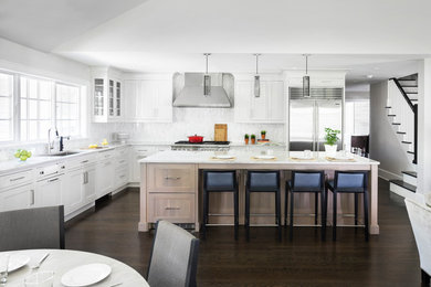 Inspiration for a large transitional l-shaped dark wood floor and brown floor open concept kitchen remodel in New York with a single-bowl sink, shaker cabinets, light wood cabinets, quartzite countertops, multicolored backsplash, mosaic tile backsplash, stainless steel appliances and an island