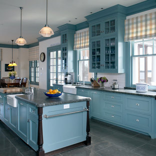 Idée de décoration pour une cuisine marine avec un placard avec porte à panneau encastré, des portes de placard bleues, une crédence rouge et un plan de travail vert.