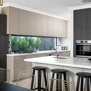 This is an example of a contemporary l-shaped eat-in kitchen in Perth with an undermount sink, flat-panel cabinets, black cabinets, window splashback, black appliances and with island.