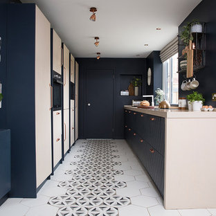 Exempel på ett litet modernt beige beige parallellkök, med släta luckor, beige skåp, flerfärgat golv och klinkergolv i keramik